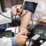 doctor masculino manos medir la tension un paciente
