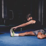 man stretching gym