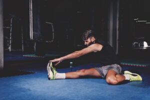 man stretching gym